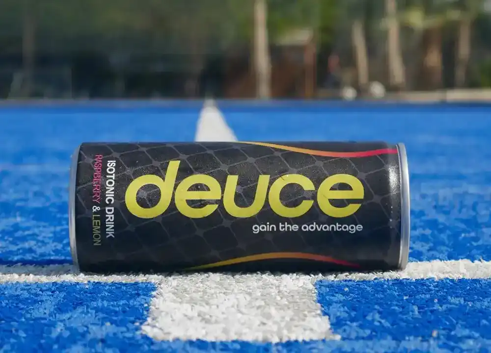 A can of deuce sitting on a blue court.