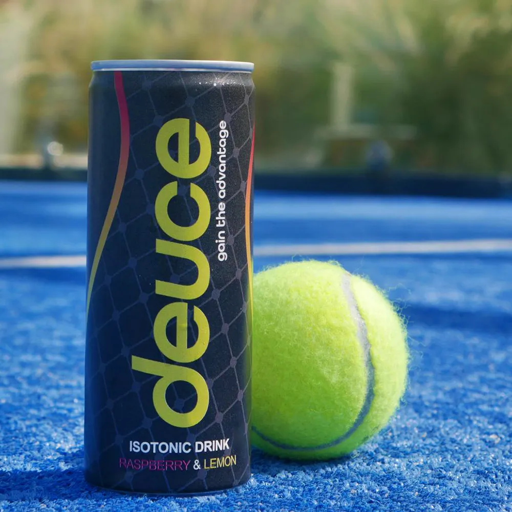 A can of deuce next to a tennis ball.